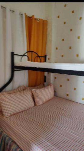 a bedroom with a bed with a shelf on top at Villa Seresa Room A in Pagsanjan