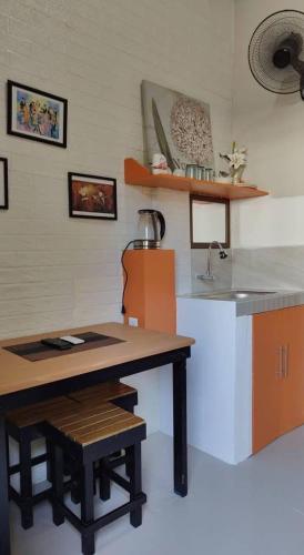 a kitchen with a table and a counter top at Villa Seresa Room A in Pagsanjan