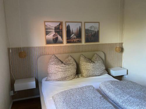 a bedroom with a bed and pictures on the wall at Casa Piedra in Kleinsteinhausen