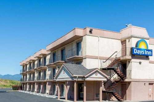 a hotel with a sign on the side of it at Days Inn by Wyndham Medford in Medford
