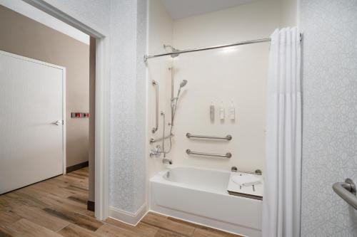 a bathroom with a shower and a bath tub at Hampton Inn Tracy in Tracy