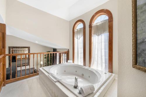 a large bath tub in a room with windows at Quality Inn Eureka Springs South in Eureka Springs