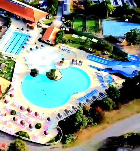 a view of a swimming pool at a resort at Bungalows climatisés en 3 ou 4ch - jusqu'à 18 voyageurs - mh732 3ch ou mh828 4ch Biscarrosse Lake-proche océan in Gastes