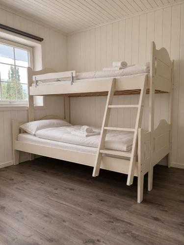two bunk beds in a room with a window at Stryn Panorama in Stryn