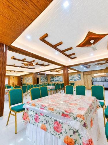 a large room with a table and chairs at Malti Guest House in Kullu Manali
