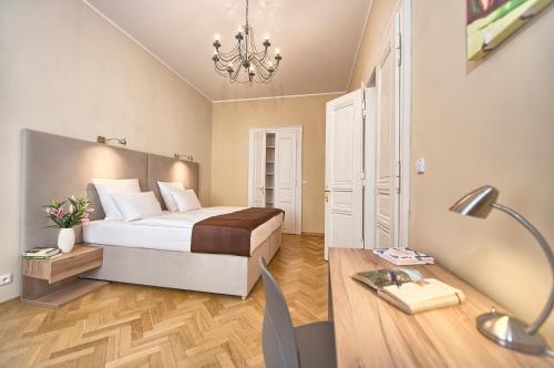 a bedroom with a bed and a desk with a lamp at Maiselova 5 Apartment in Prague