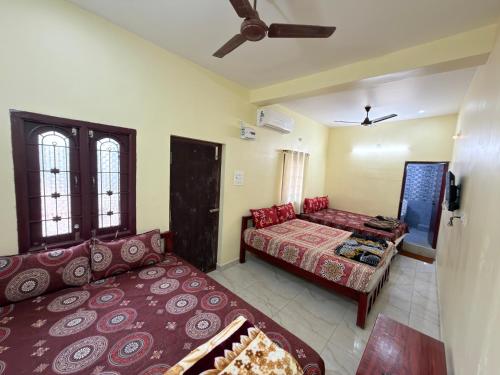 a living room with a bed and a couch at Gravity Groups VVJ - Jipmer Sangamithra in Puducherry Airpoert