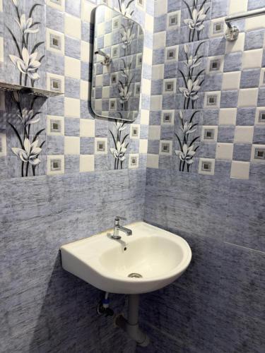a bathroom with a sink and a mirror at Gravity Groups VVJ - Jipmer Sangamithra in Puducherry Airpoert