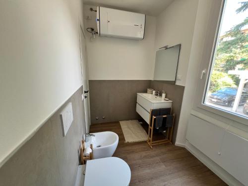 a small bathroom with a toilet and a sink at Urban Apartments RE in Reggio Emilia