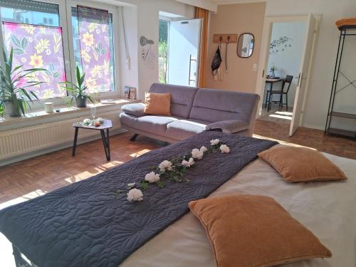 a large bed in a living room with a couch at Apartment Aigner in Reisbach
