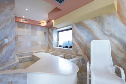 a bathroom with a toilet and a window at Hotel Centrale in Auronzo di Cadore