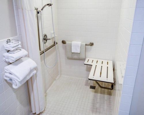a bathroom with a shower and a toilet with towels at Comfort Inn Redding Near I-5 in Redding