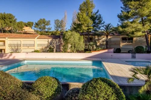 a swimming pool in front of a building at Flat With Swimming Pool Near The Beach in Sanary-sur-Mer