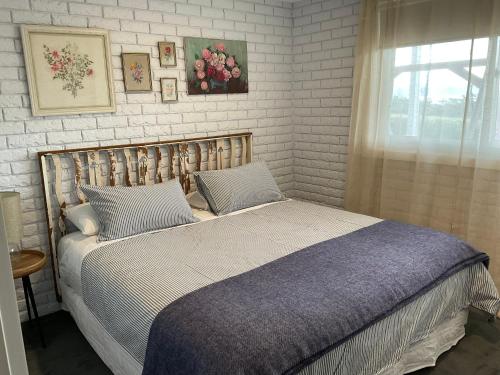 a bedroom with a bed and a window at Bruny Sunset Beach in Alonnah