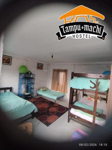 a room with two bunk beds and a sign on the wall at Tampu Machi Eco Camping in Chancayllo
