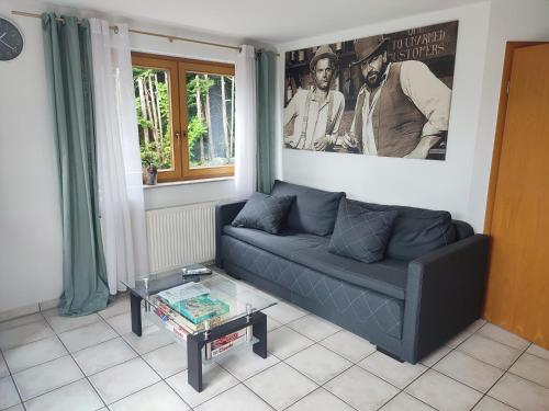 a living room with a couch and a glass table at Ferienwohnung am Trillenbühl in Salem