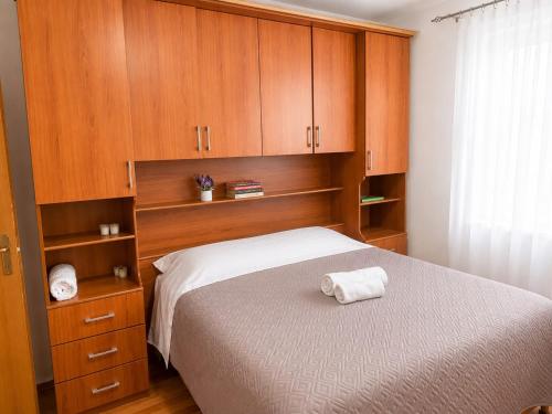 a bedroom with a bed with wooden cabinets at Cozy Apartment, Free Parking near Dajti Cable Car, Bunk'Art in Tirana