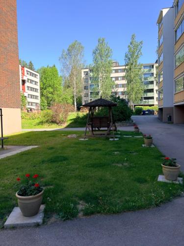 a gazebo in the middle of a lawn in a building at Peaceful studio in Vantaa in Vantaa