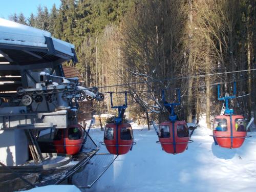 a group of three trolley cars on a ski lift at Villa Meteor in Mariánské Lázně