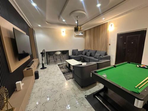 a living room with a pool table in it at Cozy 2 Bedroom Apartment - Lugbe in Rubuchi