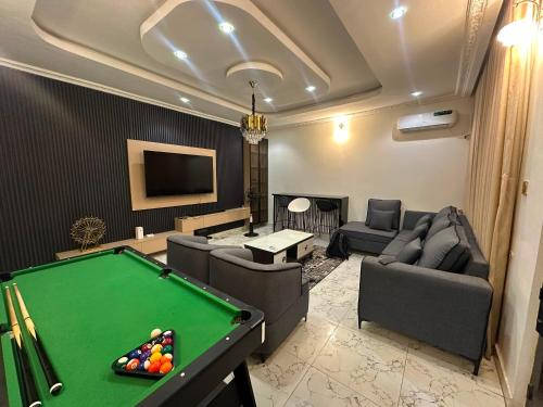 a living room with a pool table in it at Cozy 2 Bedroom Apartment - Lugbe in Rubuchi