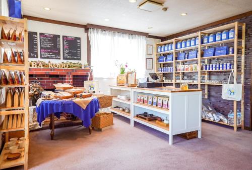 a shop with a table and shelves with shoes at REIBA STYLE Hotel in Nagasawa