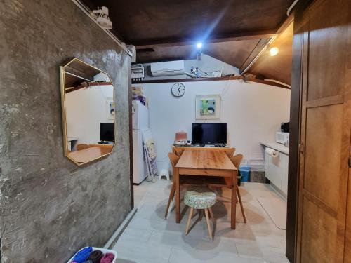 a small dining room with a table and a mirror at Ernie MyeongDon'g Sation 1Min, Anytime Check In in Seoul