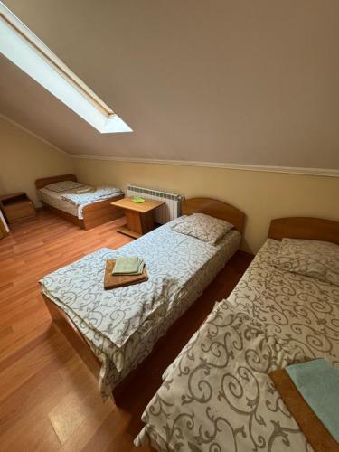 a bedroom with two beds and a skylight at Apollon in Mukacheve