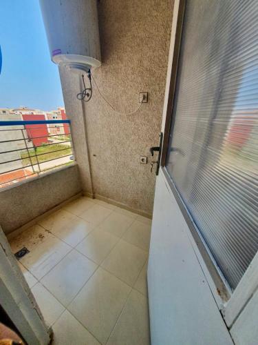 an empty room with a window and a door at Martil, Avenue Oum Kalthoum in Martil