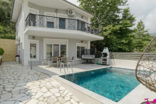 a villa with a swimming pool and a house at Diamanti Villa, Pool & Barbecue in Skala Potamias