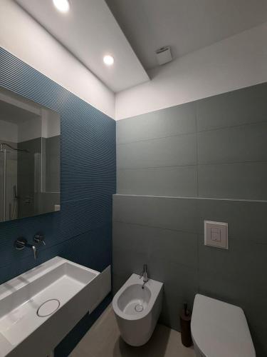 a bathroom with a tub and a toilet and a sink at Albergo Diomedee Rooms on the Beach in Rodi Garganico