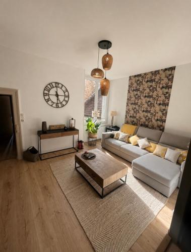 a living room with a couch and a table at Le cocon d'Avallon - terrasse privé in Avallon