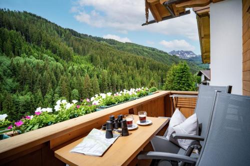 a balcony with a table and chairs and a view at Ferienwohnungen Luxner in Gerlos