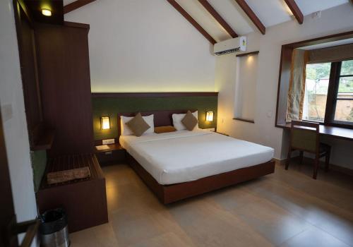 a bedroom with a large bed in a room at Misty Grove Resort in Devāla