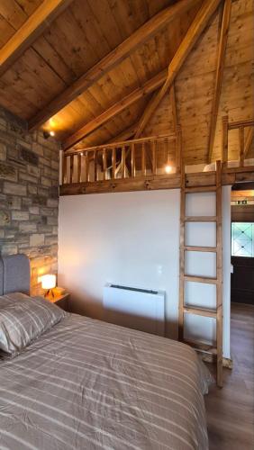a bedroom with a bed and a loft at Stone Loft Suite in Karpenisi