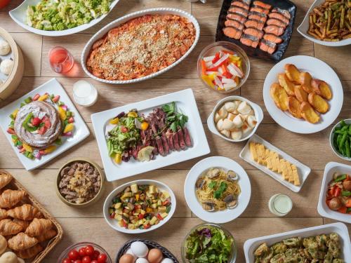 a table topped with lots of different dishes of food at Premier Hotel-CABIN-Sapporo in Sapporo