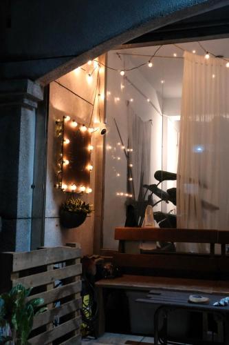 a room with lights on a wall with a bench at Island River in Green Island