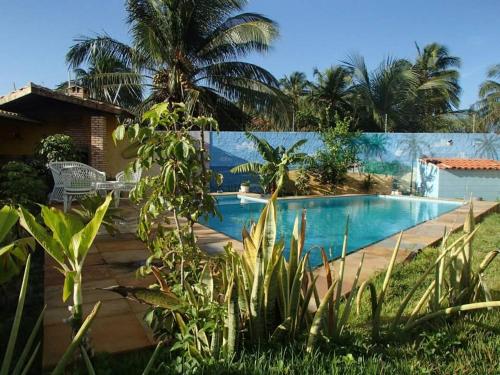 a house with a swimming pool in a yard at Châle guesthouse in Paracuru
