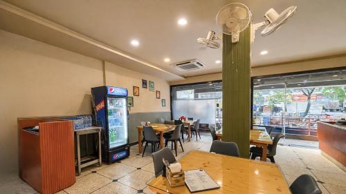 a dining room with a table and a video game at Sumitel Premier Inn in Siliguri