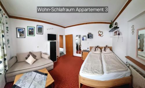 a room with two beds and a couch at Appartement Schuller in Wagrain
