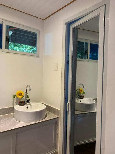 a bathroom with two sinks and two mirrors at Yaga's Stay INN save in Impasugong