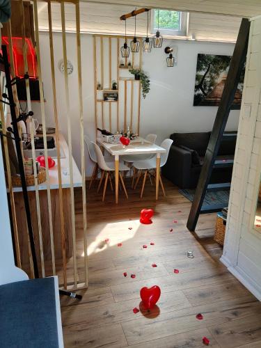 a room with a table with red rose petals on the floor at 2R Relax Resort in Ubyszów