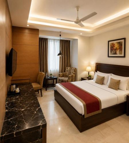 a hotel room with a bed and a desk at Hotel Good Will Residency - DLF Cyber City Gurgaon in Gurgaon