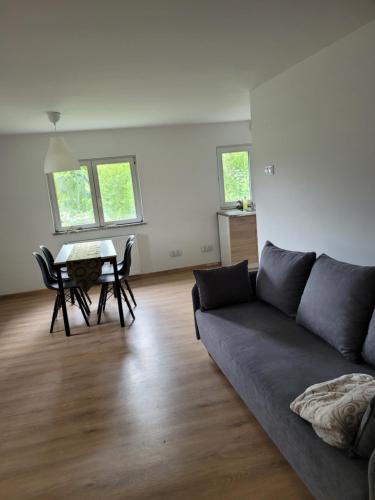 a living room with a couch and a table at Bobrowe zacisze in Wleń