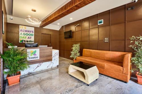 a lobby with a couch and a sign that reads always a good day at mercy at Treebo Sky Vista Suites with Hill View in Chikmagalūr