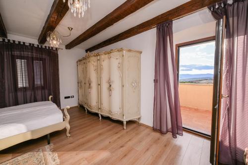 a bedroom with a bed and a large window at House Polic in Hreljin
