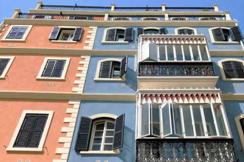 a tall building with windows and balconies at Grand Central House - Classic Studio - GibraltarStay Apartments in Gibraltar