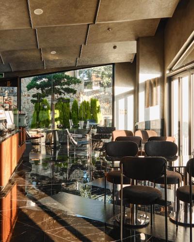 a bar with chairs and a glass floor at Adela Hotel Dalat in Da Lat
