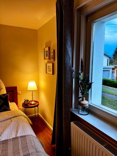a bedroom with a window with a bed and a table at Appartement Frieda in Seeboden