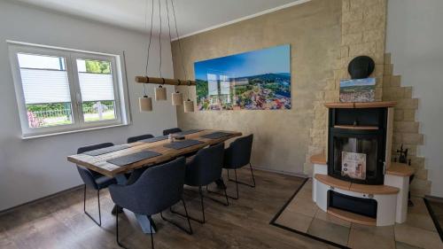 a dining room with a wooden table and chairs at Ferienhaus freiZeit in Rudolstadt
